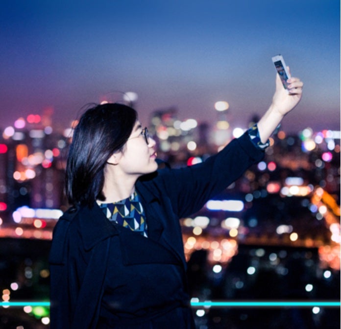 Young Chinese taking selfie photo